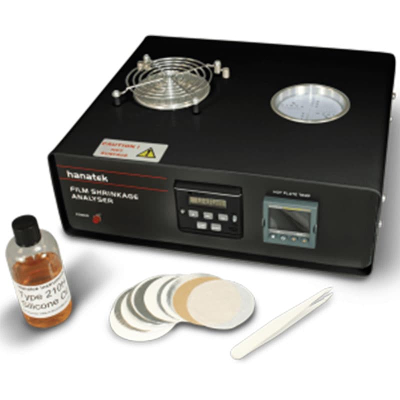 Hanatek Film Shrinkage Analyser with accessories – The film shrinkage analyser is displayed with test sample discs, tweezers, and a bottle of silicone oil, essential for accurate shrinkage measurements.