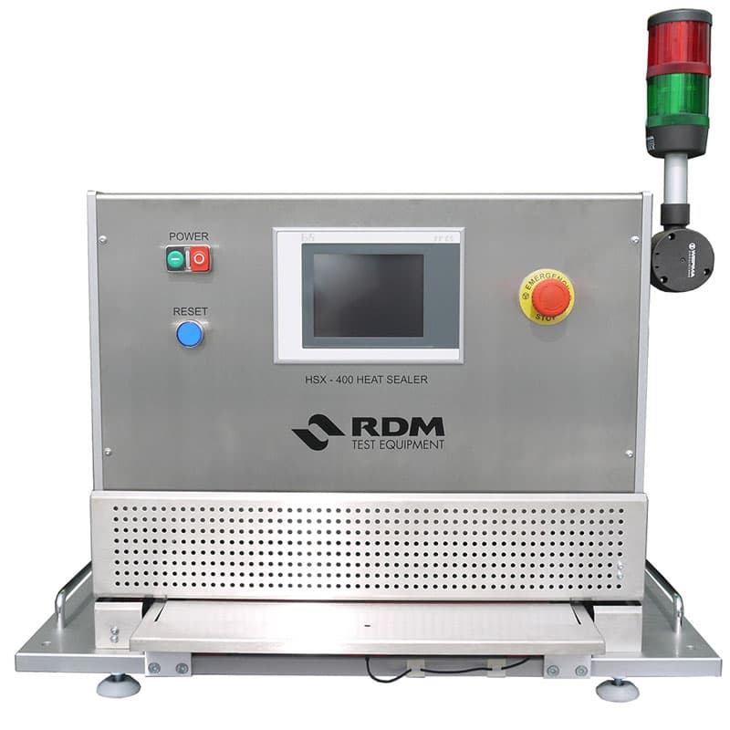 RDM HSX-400 medical heat sealer with touchscreen control panel, emergency stop button, and signal tower for sterile packaging seal testing.