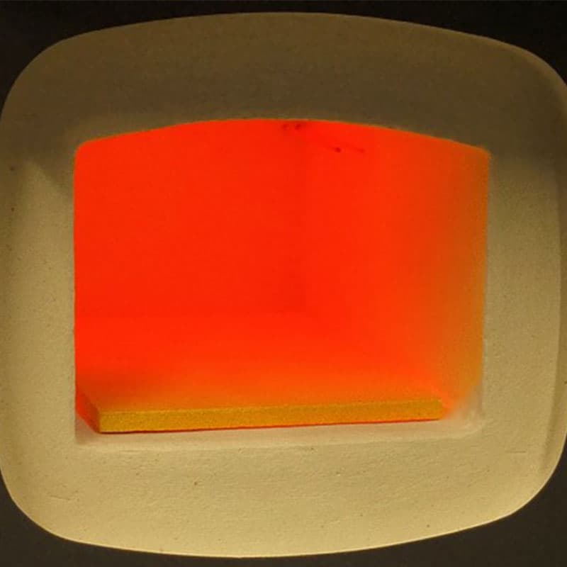 Interior of SNOL 1100°C laboratory furnace showing the insulated chamber glowing at high temperature.