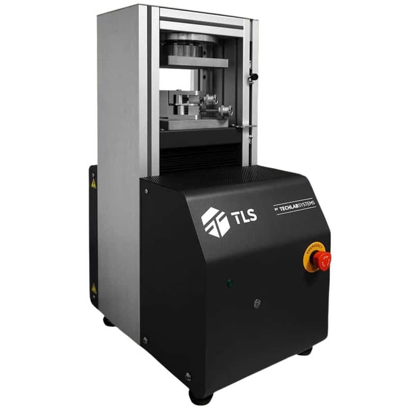 Laboratory crush tester machine for paper and corrugated cardboard compression testing.