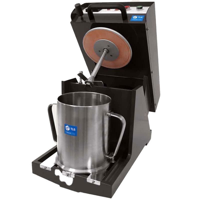 Open pulp disintegrator with stainless steel container and visible internal rotor mechanism.