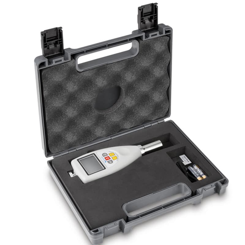 A Sauter Shore Hardness Tester stored inside a protective carrying case with foam inserts, along with accessories like batteries and a calibration tool.