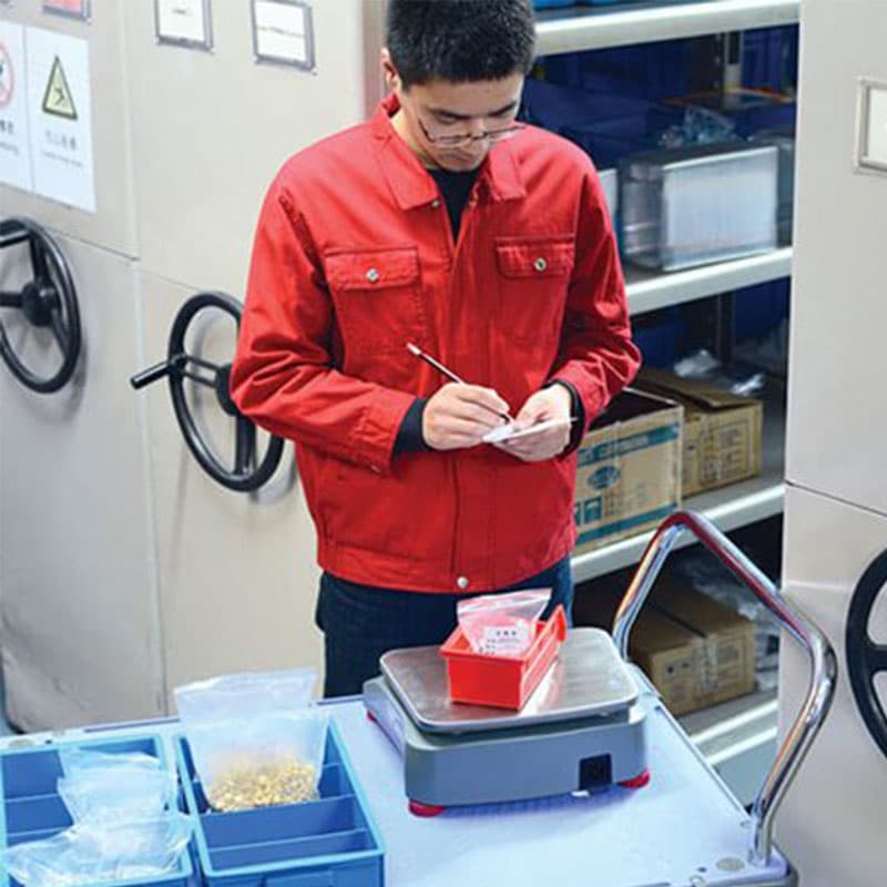 Warehouse worker using Ohaus Ranger 4000 Compact Scale on mobile workstation.