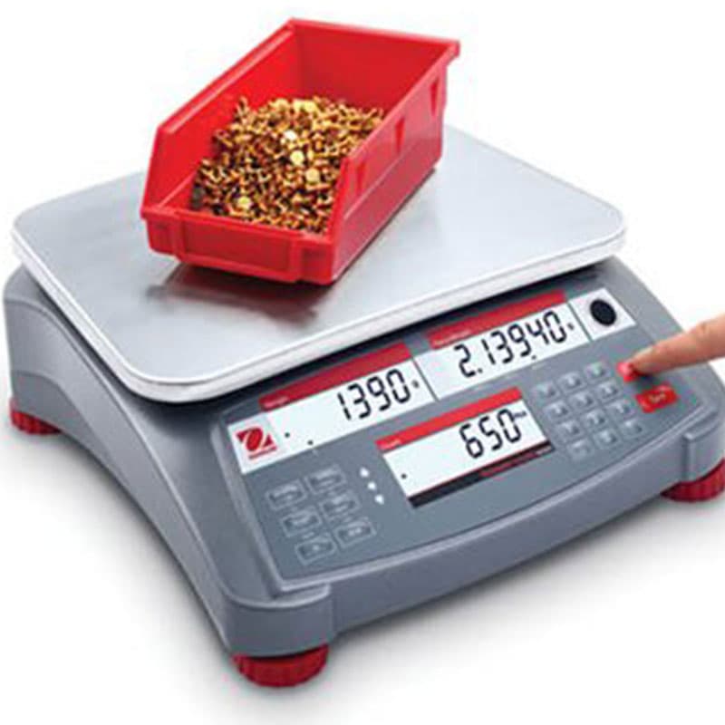 Red bin of brass parts on OHAUS Ranger Count 4000 scale showing part count and total weight.
