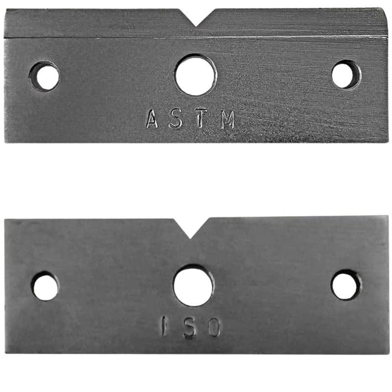 ASTM and ISO metal test specimens with V-notches for Charpy-Izod impact testing.