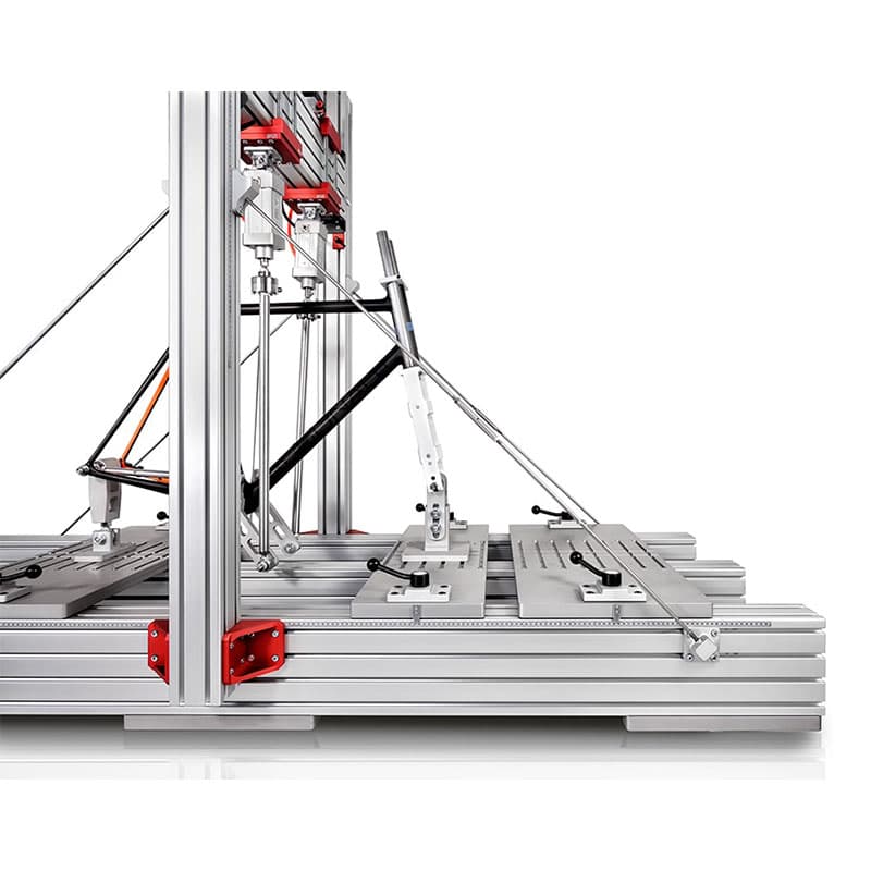 This image focuses on the side view of the bike frame, which is mounted within the metallic structure. The fatigue testing machinery around it is designed for precise adjustments, likely for testing the frame's alignment or durability.