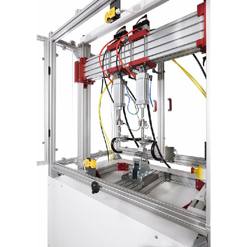Interior view of LiTeM BYC 200 fatigue testing machine showing dual linear actuators, modular aluminum frame, and specimen mounting platform.
