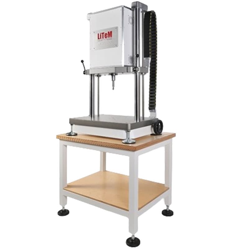 LiTeM ELDY 10 fatigue testing machine with enclosed actuator, dual vertical columns, and base platform mounted on a laboratory table for cyclic fatigue testing.