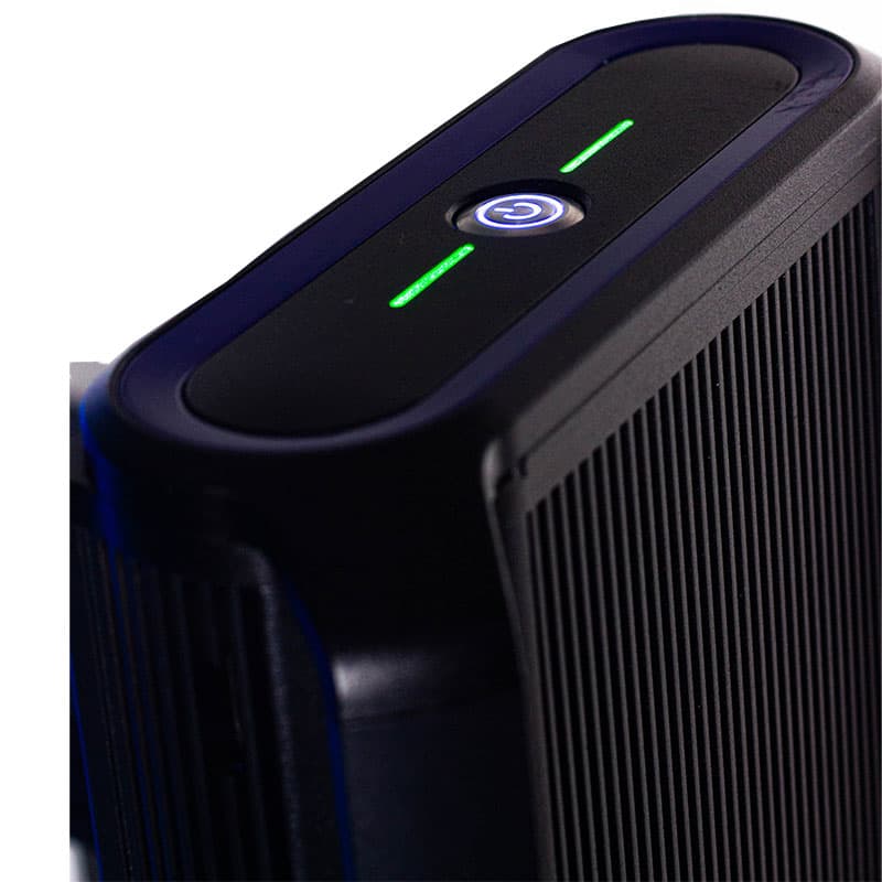 This close-up image focuses on the top of a black extensometer, showcasing its power button, illuminated with a blue light, and green indicators. The design is sleek with a modern appearance, featuring a ribbed texture along the sides. The lighting is low, emphasizing the illuminated elements and giving the instrument a high-tech, sophisticated feel.