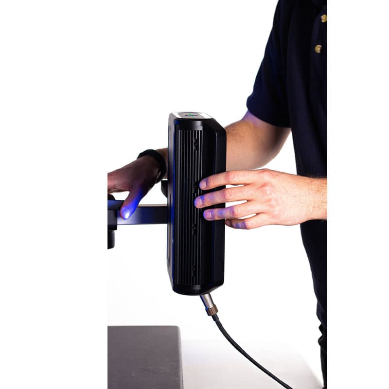 This image shows a close-up of a person's hands adjusting or interacting with the Vector U200 extensometer. The person is wearing a dark short-sleeved shirt, and their hands are in focus while the rest of the person is partially out of frame. The background remains plain white, with the lighting highlighting the equipment and hands, giving the scene a clean, technical feel.