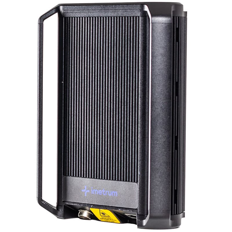 This image showcases a detailed view of a black, ribbed industrial device with the brand name "Imetrum" prominently displayed on the front. The extensometer has a sturdy, protective casing and is designed for precision work, in a testing or measurement context. The background is plain white, making the device the central focus of the image.