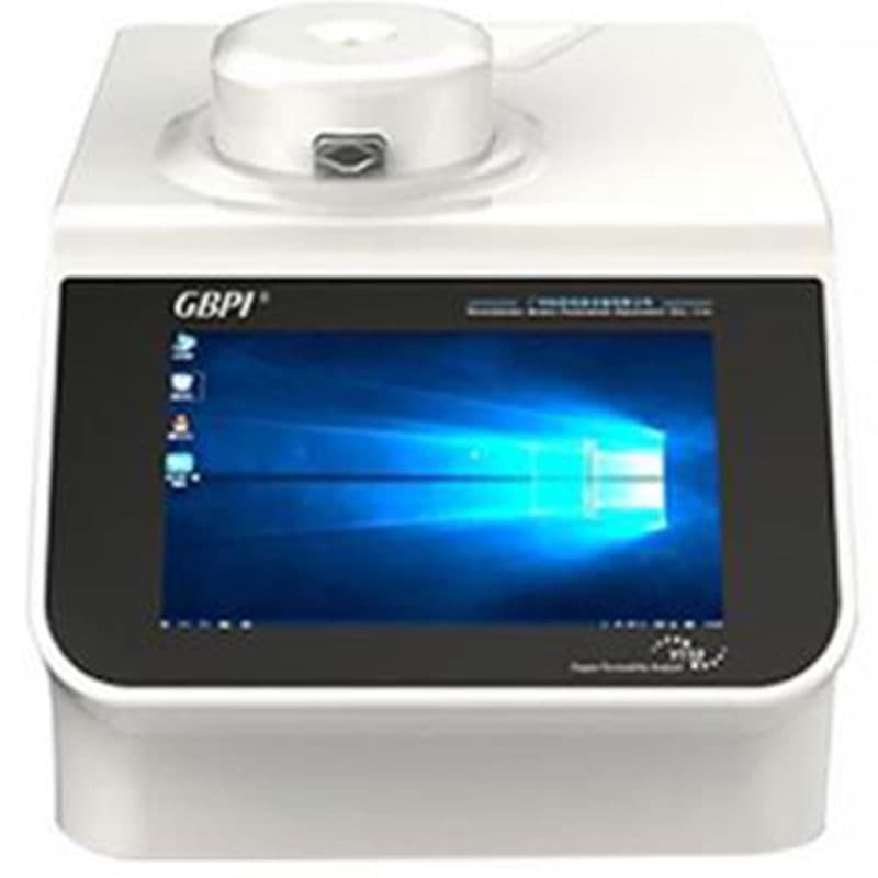 Compact gas permeability analyser with a white body, integrated touchscreen display showing a Windows interface, and a circular testing chamber on top.
