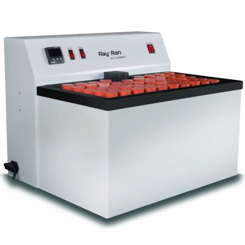 Ray Ran environmental stress cracking tester with a white body, black top surface, orange specimen holders, and control panel with switches and a digital display.