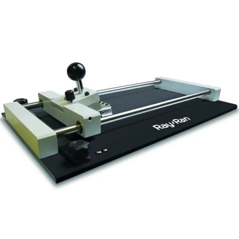 Ray-Ran precision sample cutter with dual guide rails, adjustable cutting mechanism, ergonomic handle, and sturdy base for creating uniform material specimens in laboratory settings.