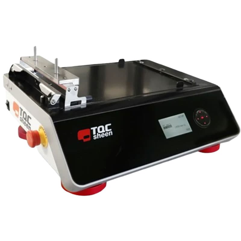 TQC Sheen automatic film applicator with a black and silver design, perforated application table, and digital control panel for precise film application.