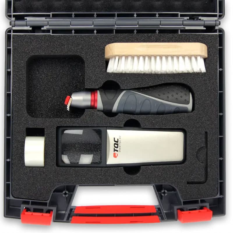 Cross hatch adhesion tester toolkit with a tester, cleaning brush, magnifier, and accessories, organised in a foam-lined carrying case.
