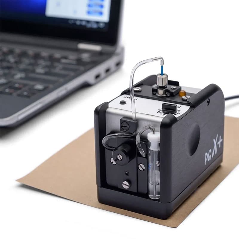 PGX+ contact angle meter connected to a laptop, showing its integration with software for real-time surface tension measurements.