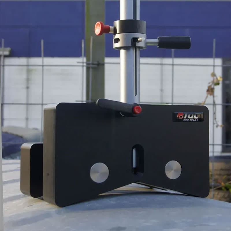 TQC Sheen adhesion tester in an outdoor setup, with a black testing head and adjustable rod placed on a metallic surface for on-site adhesion testing.