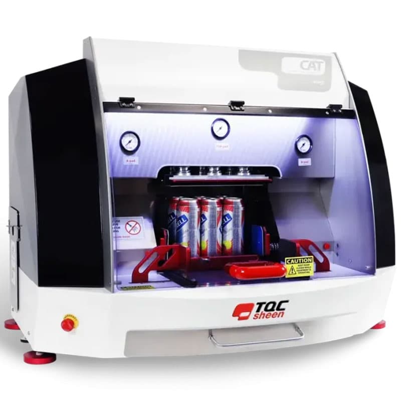 TQC Sheen CAT abrasion testing machine with transparent enclosure, digital pressure gauges, and multiple cans inside for durability testing.