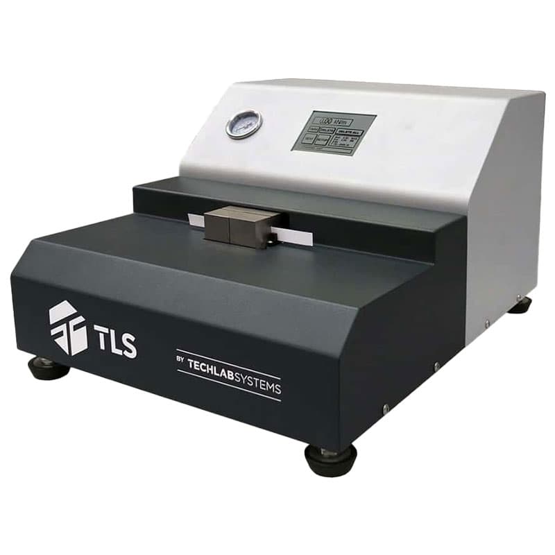 "TLS industrial S-TEST compression testing machine with a clamping mechanism, digital control panel, pressure gauge, and branding by TechLab Systems."