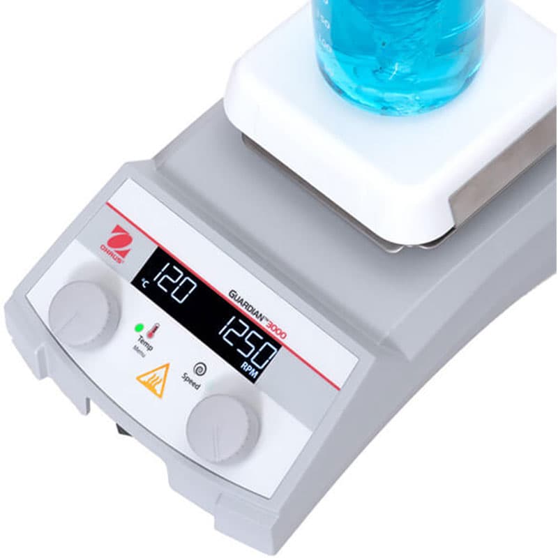 Angled top view of Guardian 3000 hotplate stirrer with blue liquid at 120°C and 1250 RPM.