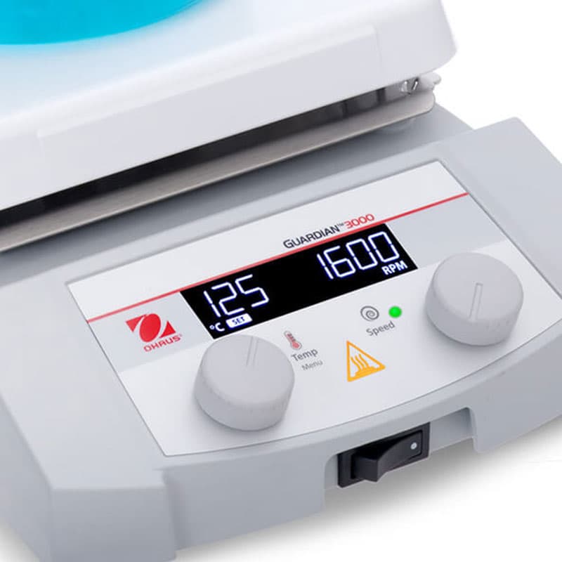 Close-up of OHAUS Guardian 3000 stirrer control panel showing 125°C and 1600 RPM settings.