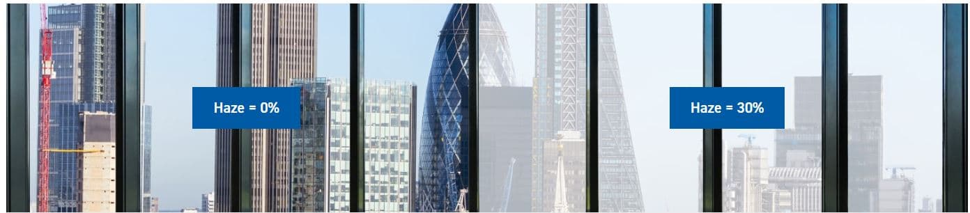 Side-by-side view through glass panels showing 0% haze (clear) versus 30% haze (foggy), with a cityscape background.