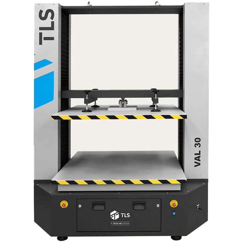 Frontal view of the VAL-30 compression tester with yellow-black striped platforms and vertical columns.