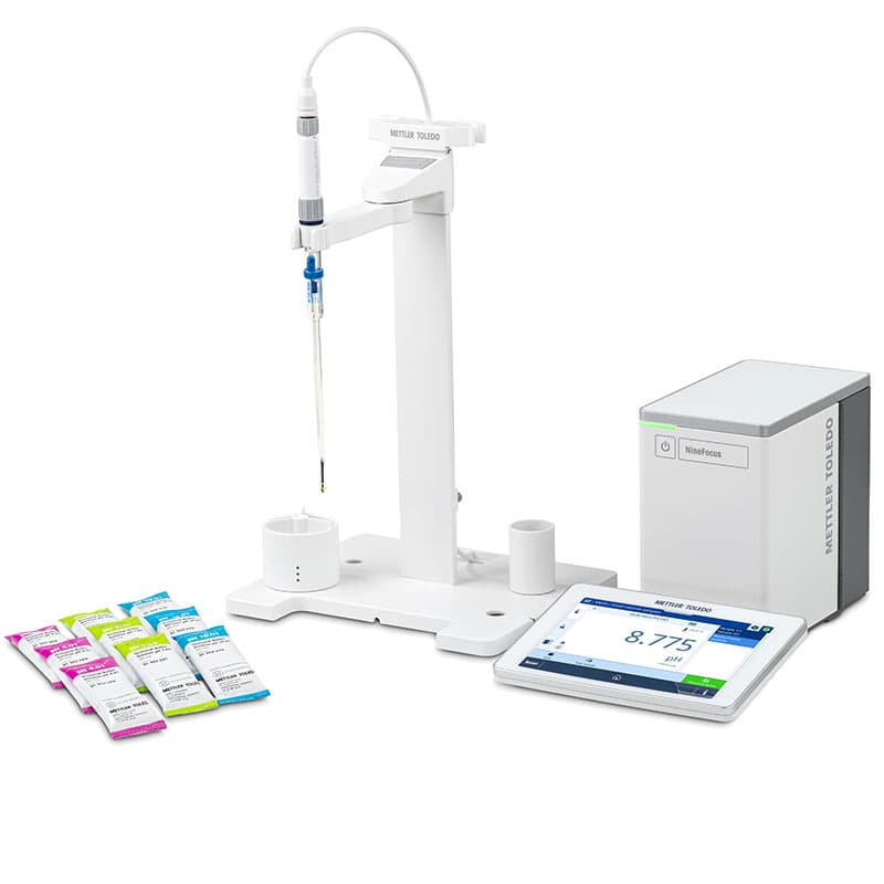 METTLER TOLEDO NineFocus NF2000 LowVol pH meter kit with electrode stand, glass probe, touchscreen display showing pH 8.775, control unit, and calibration buffer sachets.