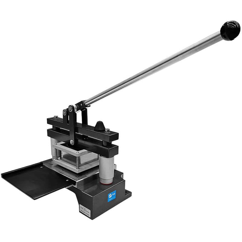 Angled view of manual punch die press showing lever mechanism and die assembly.