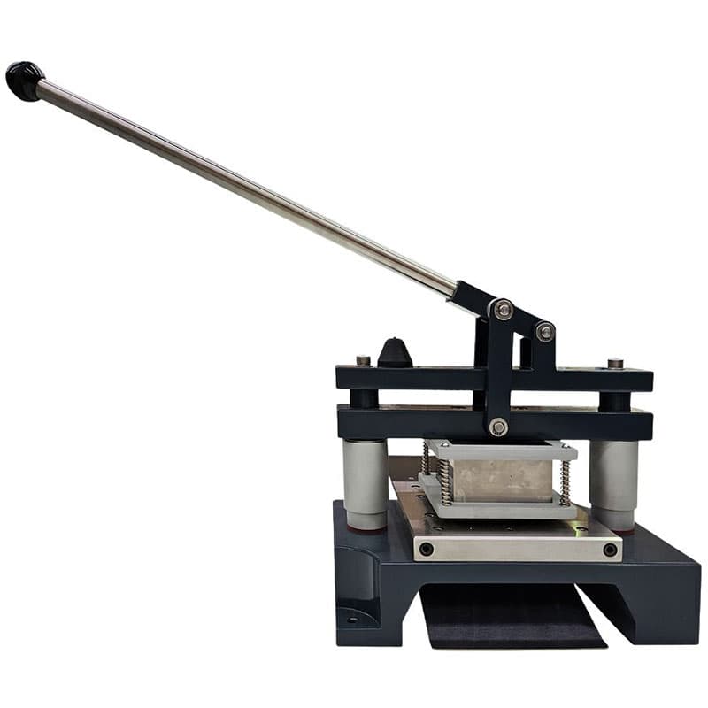 Front view of manual punch die press with lever raised above die area.
