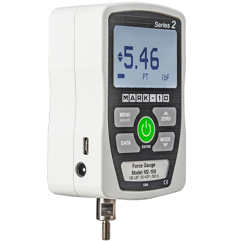 Angled view of Series 2 M2-100 digital force gauge showing LCD, controls, side ports, and bottom threaded connection.