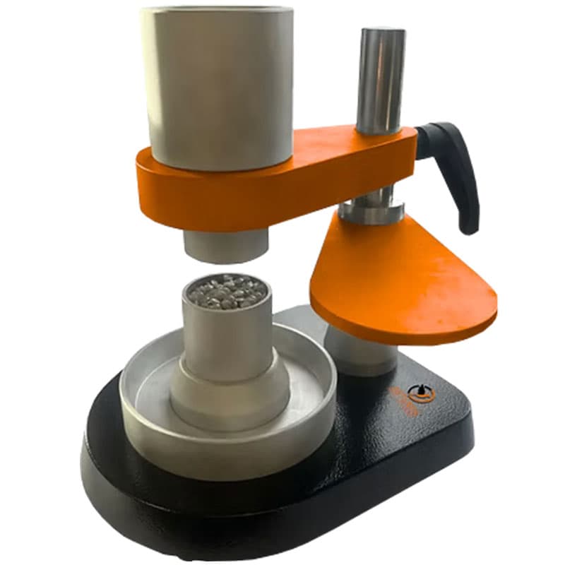 Artemis ISO R60 bulk density apparatus with cylindrical reservoir, adjustable support, discharge opening, and receiving vessel containing granular material.