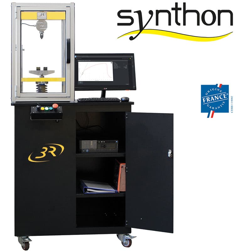 Front view of the SYNTHON 25 kN Teaching Universal Testing Machine with enclosed test frame, computer workstation, monitor, and machine controls.
