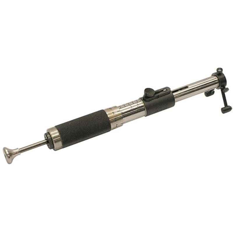 Handheld Enamel Impact Tester with stainless steel body, black grip and graduated measurement scale.