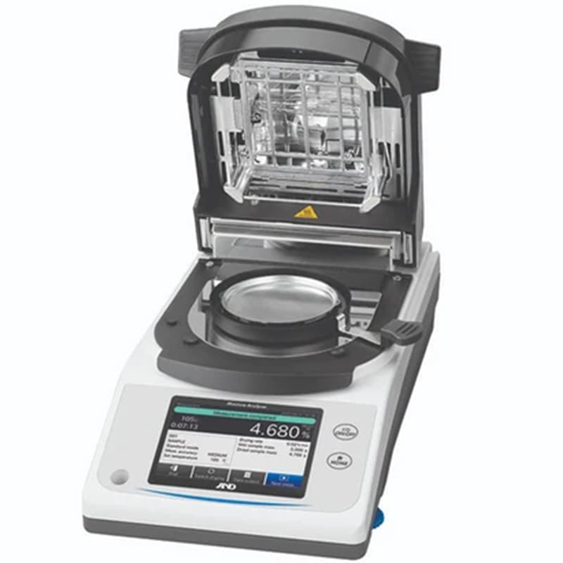 MS-74AT Moisture Analyser with heating chamber open, showing the sample pan and internal heating assembly.
