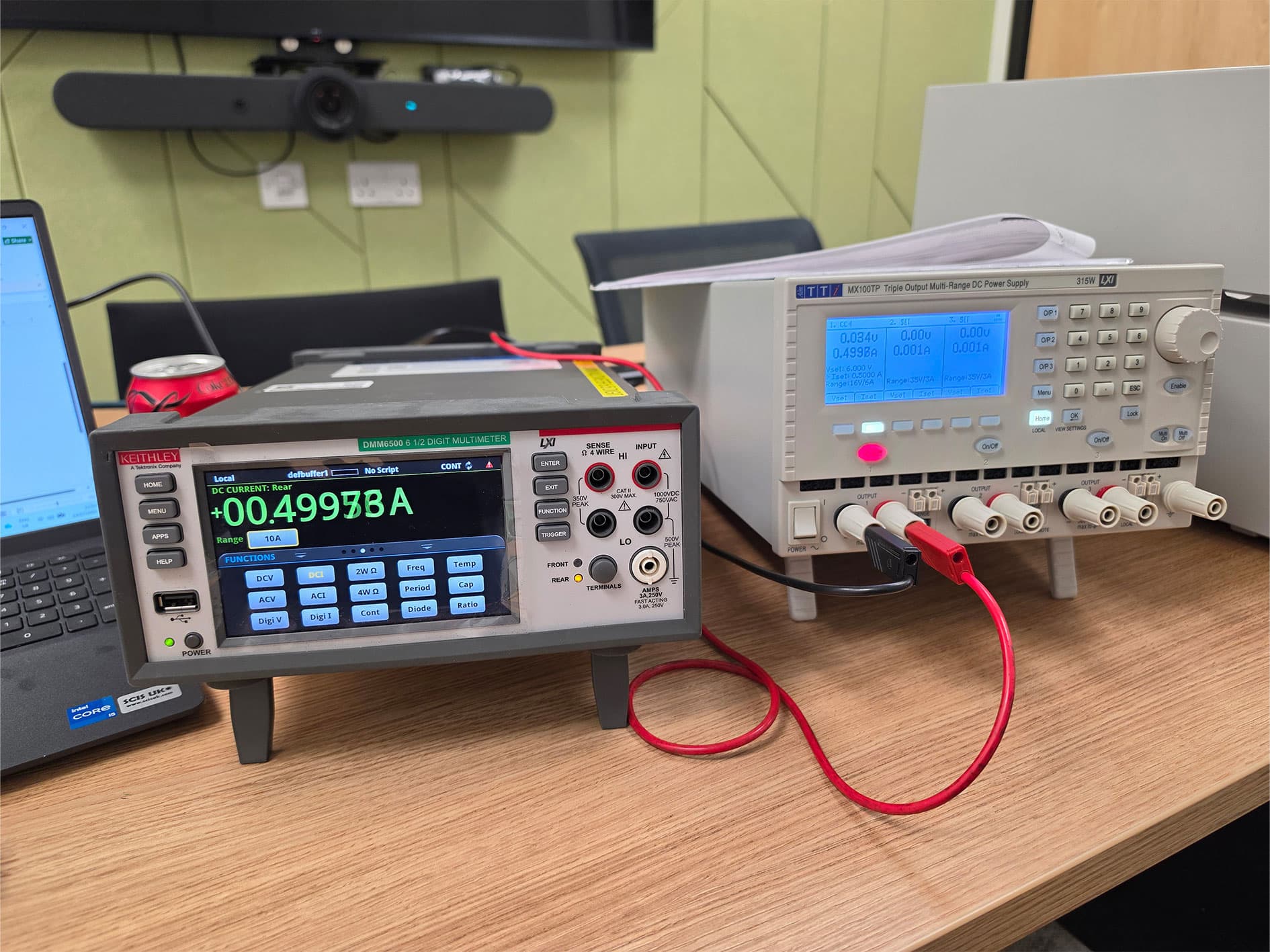 Keithley DMM6500 multimeter measuring approximately 0.5 A DC from a TTi MX100TP power supply during calibration.