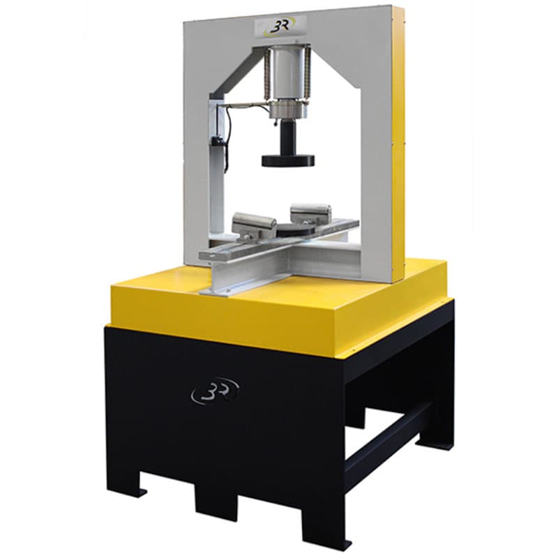 Gantry-type flexural testing machine with central vertical loading actuator, loading head, adjustable roller supports, and heavy-duty floor-standing base.