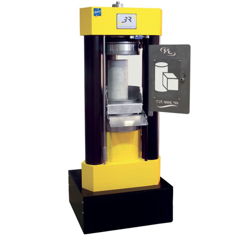 Three-column compression testing machine with a rigid load frame and compression platens for testing the compressive strength of concrete and other construction materials.
