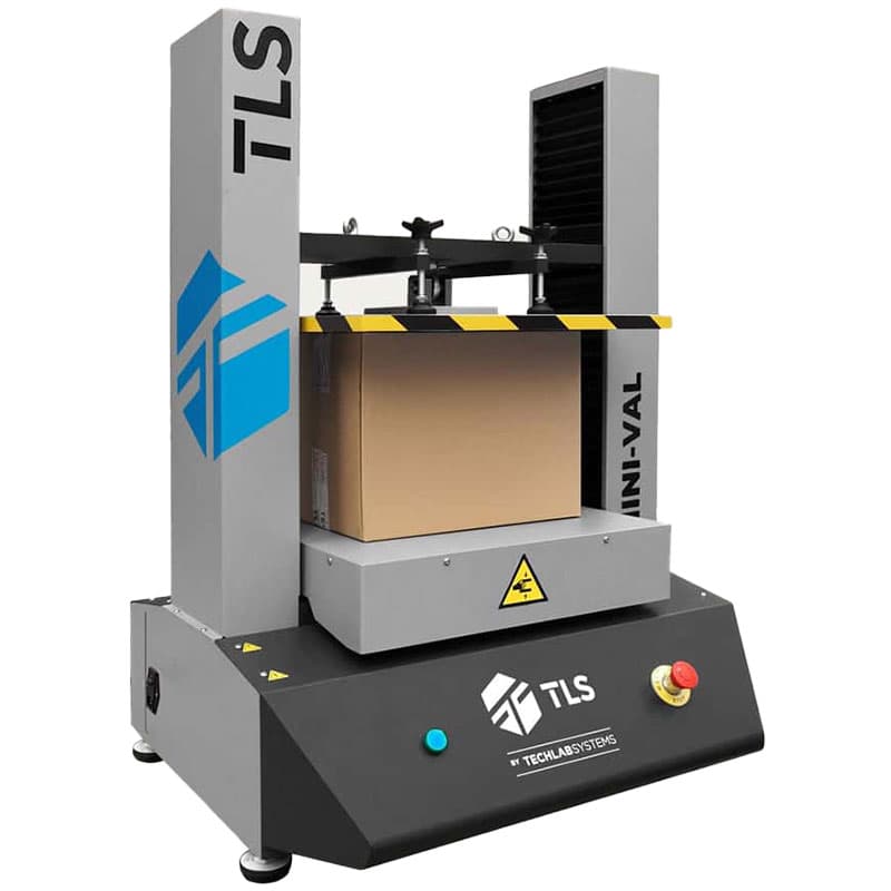 MINI-VAL compression tester applying force to a cardboard shipping box.