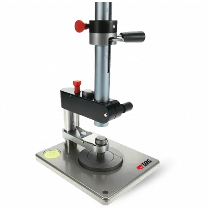 TQC Sheen coating thickness gauge with a metal base, vertical adjustment rod, and precision controls for measuring coating thickness on flat surfaces.