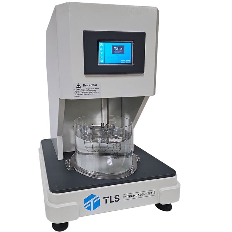 Angled view of water absorption testing machine with visible basket and touchscreen interface.