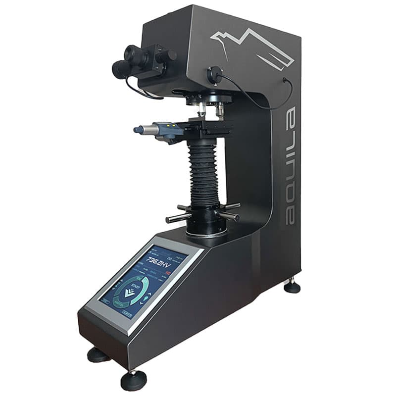 AQUILA microhardness tester with digital touchscreen, optical eyepieces, and motorised stage.