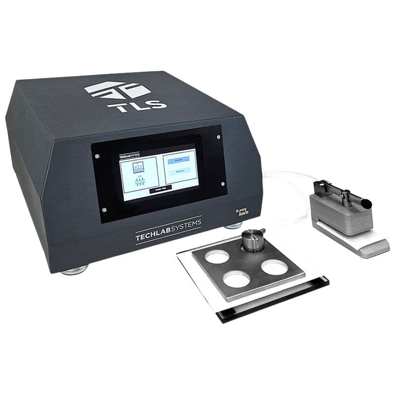 TLS Bendtsen roughness and porosity tester with touchscreen display and testing accessories for measuring paper surface roughness and air permeability.
