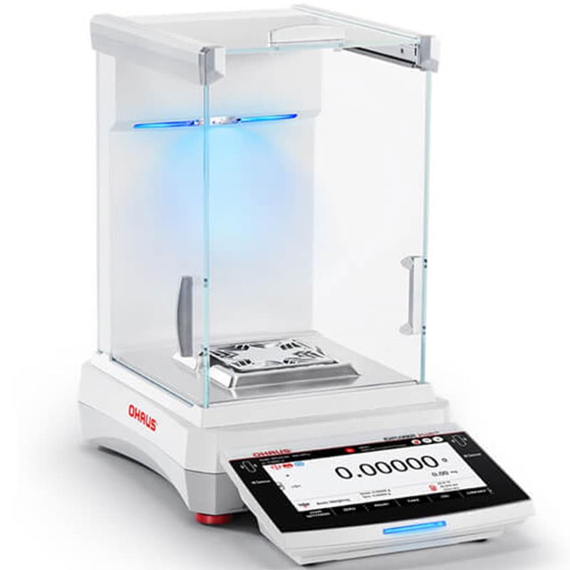 OHAUS Explorer Plus Semi-Micro balance with blue illumination inside its glass draft shield, a stainless steel weighing pan and a touchscreen displaying 0.00000 g.