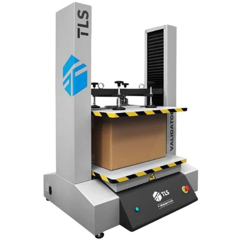 Box compression tester machine by TLS with a cardboard box placed between two compression plates.