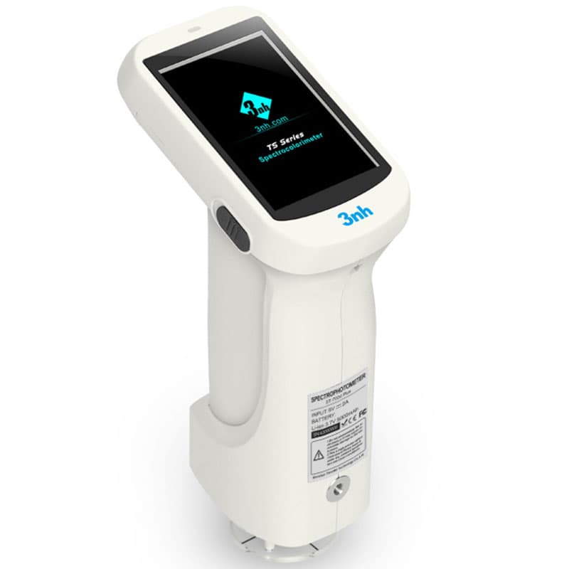 Handheld spectrophotometer with ergonomic grip and startup display screen.