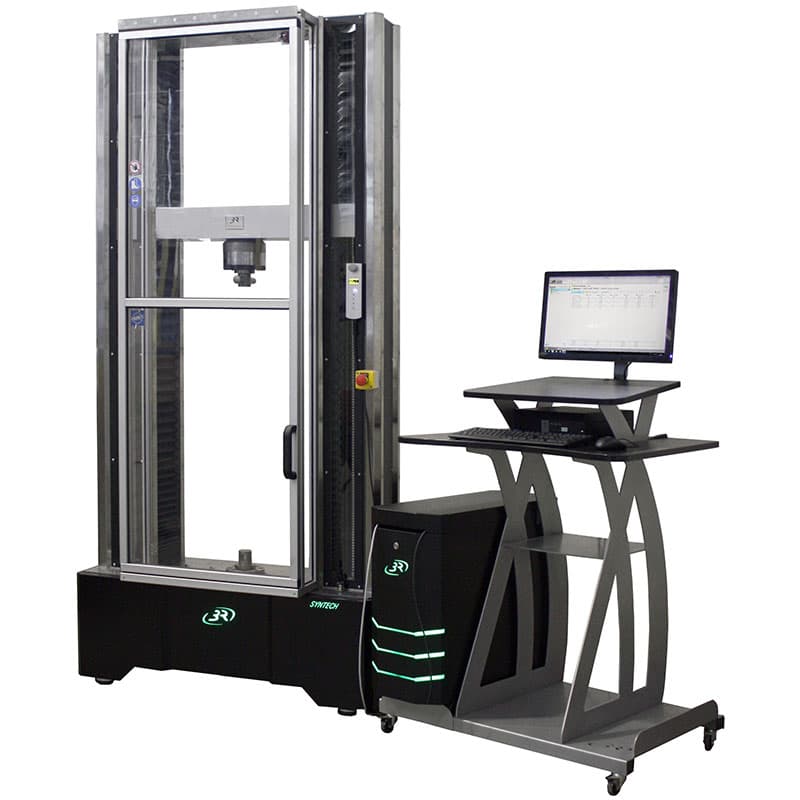 SYNTECH 150 Compact Electromechanical Universal Testing Machine with transparent safety door closed and computer workstation alongside.