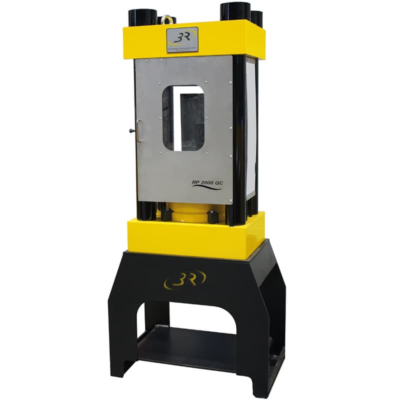 Four-column compression testing machine with protective safety door closed and viewing window for observing the test chamber.
